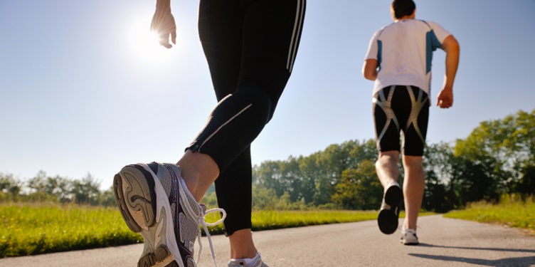 Young couple jogging in park at morning. Health and fitness.