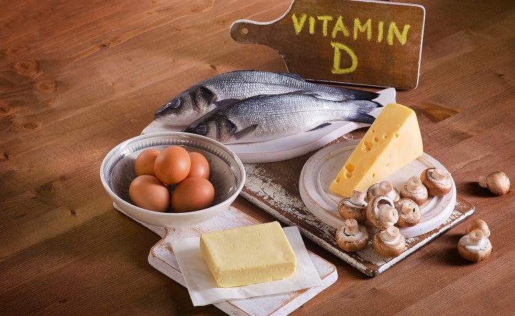 Foods containing vitamin D on a wooden background.